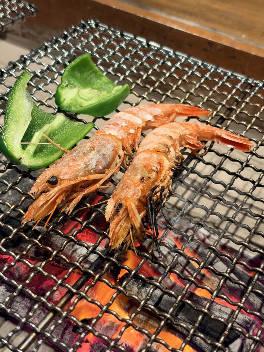 囲炉裏の網で焼くエビとピーマン